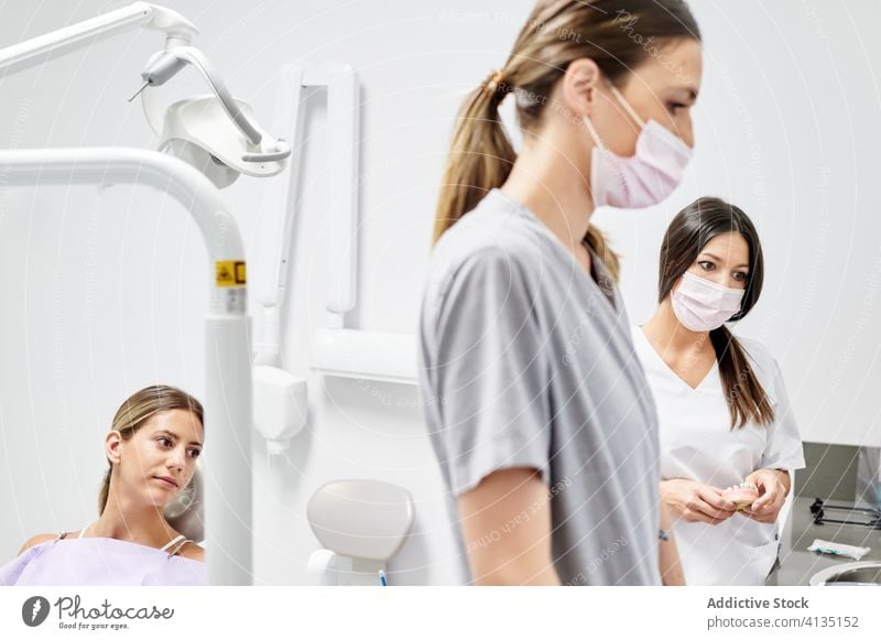 Happy woman during appointment in dental clinic women patient dentist smile assistant modern visit check up cheerful chair oral hygiene dentistry office