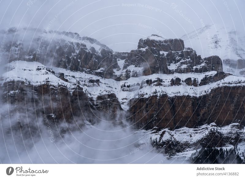 Mountain covered with snow and fog in winter mountain landscape breathtaking haze spectacular idyllic nature scenery picturesque climate range gloomy tranquil