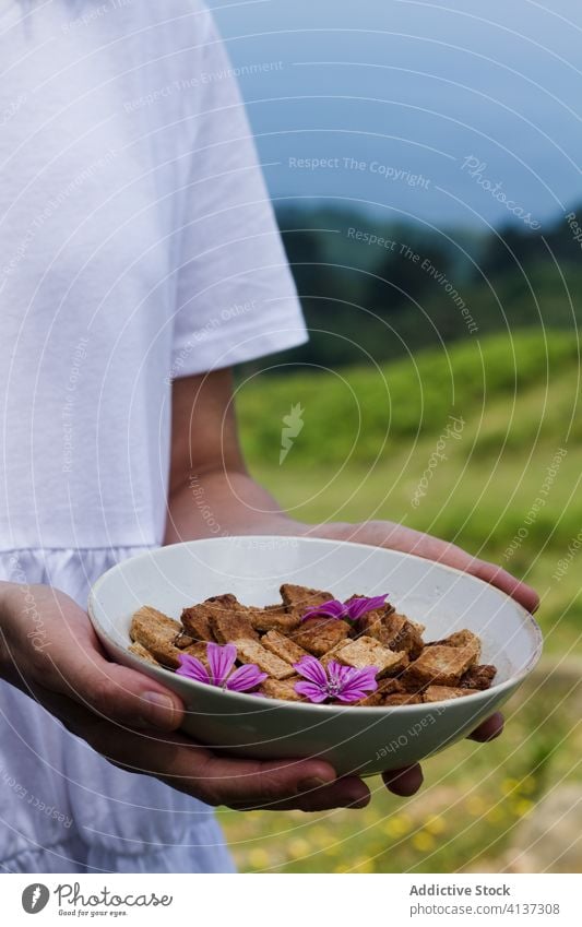 Crop woman with bowl of cereal breakfast cinnamon countryside morning yummy crunch crispy female ceramic food tasty delicious dessert healthy sweet ingredient