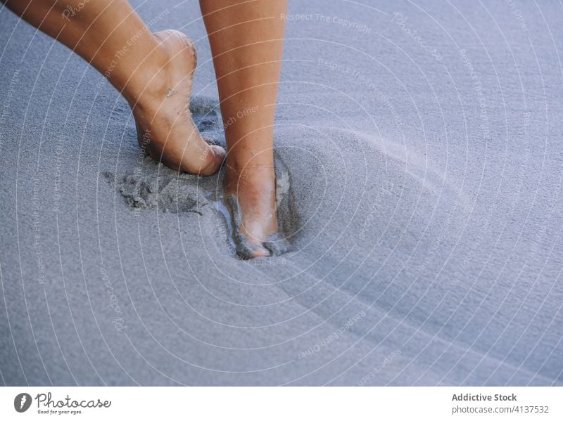 Crop woman on sandy beach during vacation barefoot enjoy carefree seashore summer holiday female slim feet coast walk relax travel waterfront seaside seafront