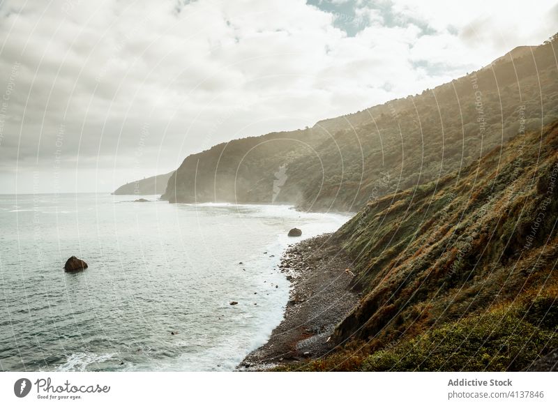 Hill with grass near sea under cloudy sky hill wave seascape breathtaking picturesque foam harmony nature paradise skyline peaceful spectacular horizon idyllic