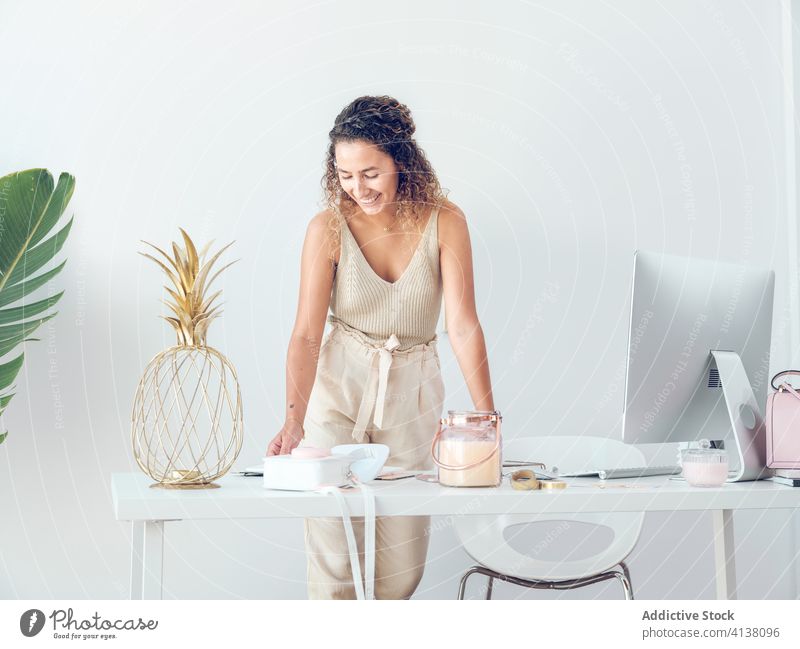 Cheerful woman reading notebook in office notes business smiling work table leaning female palma de mallorca spain style elegant trendy cheerful happy job