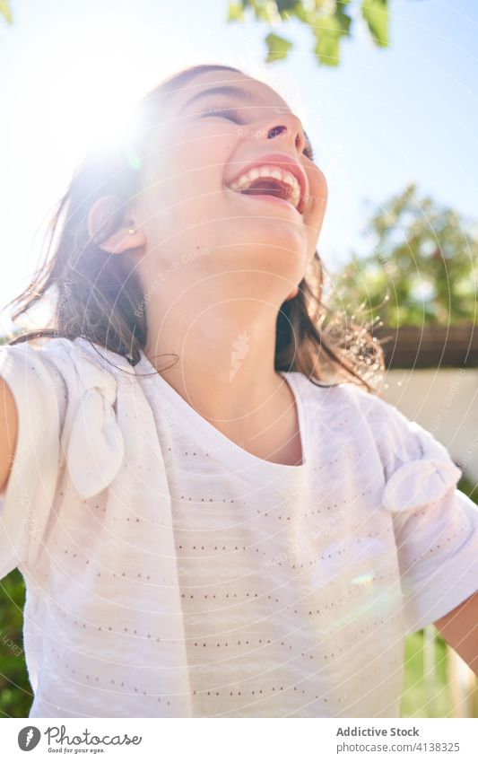 Happy girl enjoying summer day happy delight laugh kid carefree cheerful fun sunny garden child optimist glad childhood positive excited content vacation park