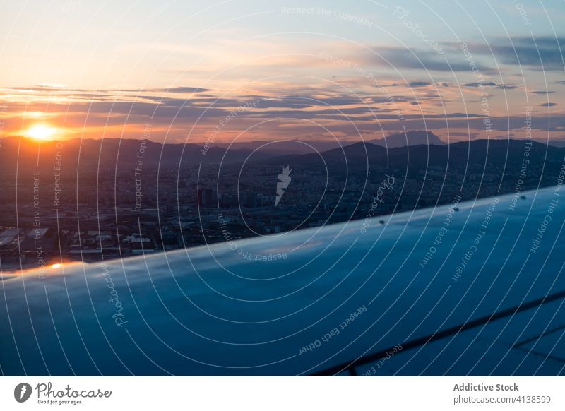 Airplane wing and clouds at sunset light airplane fly sky aircraft flight travel tourism trip sunlight transport journey aviation jet atmosphere freedom vehicle