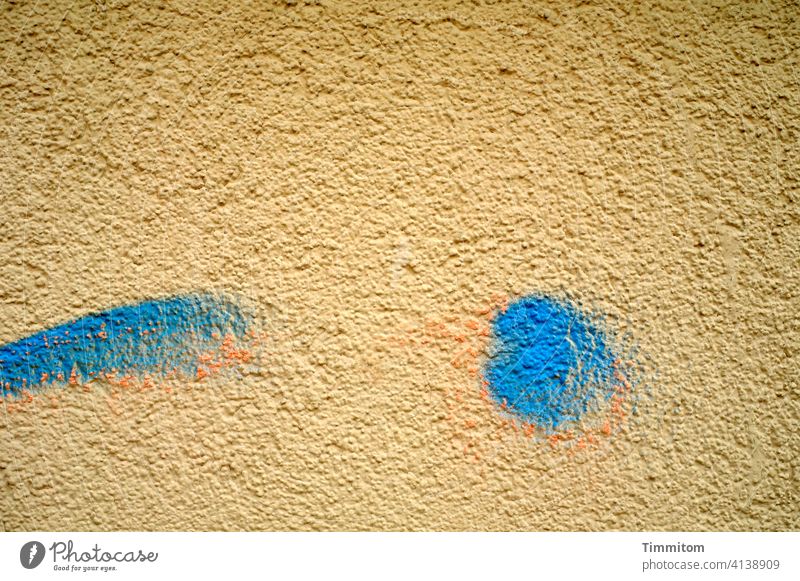 A tongue-in-cheek facade (partial view) Facade Wink roughcast Wall (building) Plaster House (Residential Structure) Colour Ochre Blue Orange cheerful Deserted