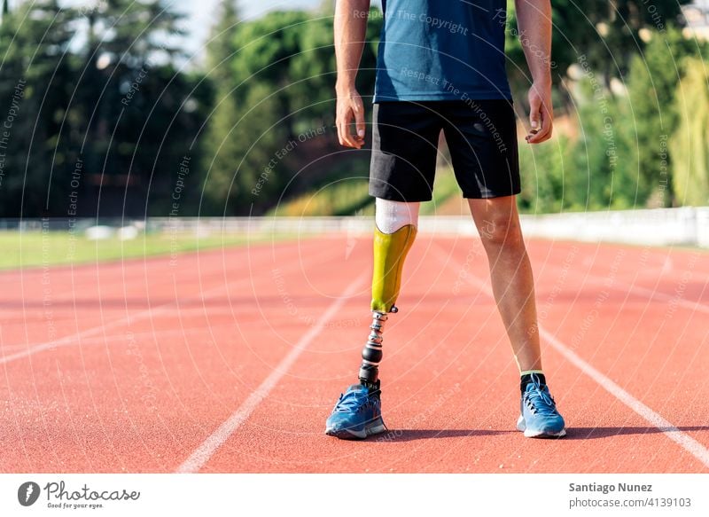 Close up disabled man athlete with leg prosthesis. runner portrait sport legs prosthetic faceless unrecognized anonymous sports wear sports clothes disability