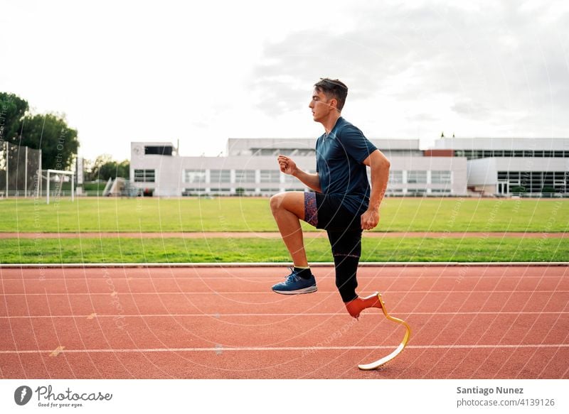 Disabled Man Athlete Running side view running practicing man runner athlete sport prosthesis prosthetic disability disabled paralympic boy amputation amputee