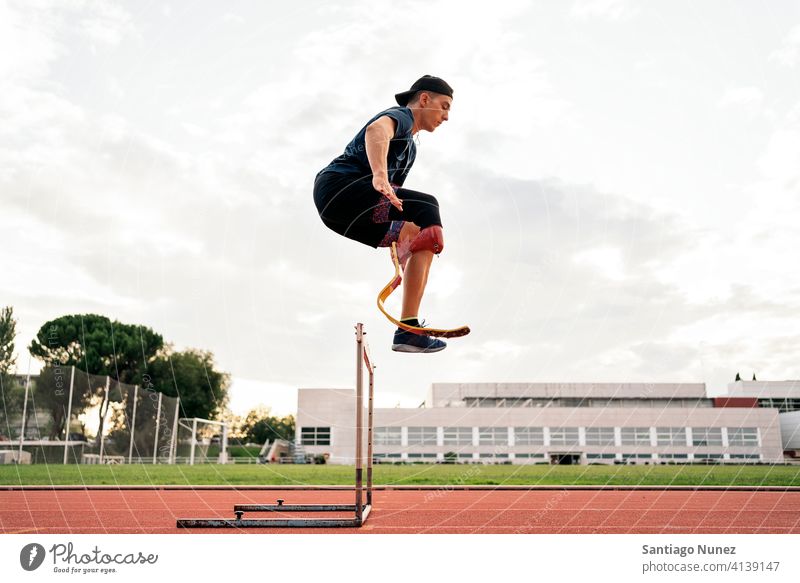 Disabled Man Athlete Jumping side view boy young man run runner running jump jumping athlete sport prosthesis prosthetic disability disabled amputation