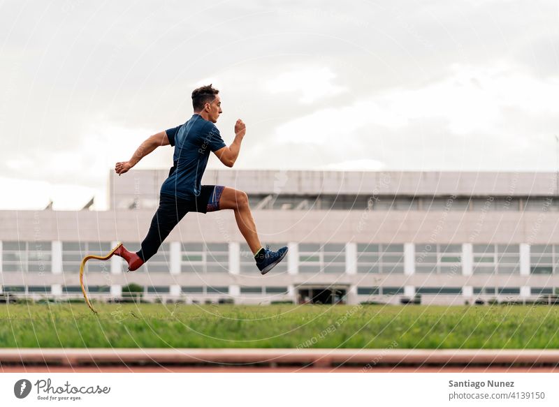 Disabled Man Athlete Running side view running practicing man runner athlete sport prosthesis prosthetic disability disabled paralympic boy amputation amputee