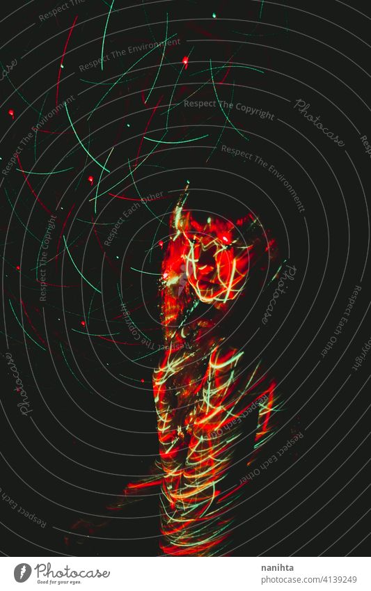 Experimental portrait of a young woman illuminated in the dark by a light projector spotlight female body party background underground experimental green red