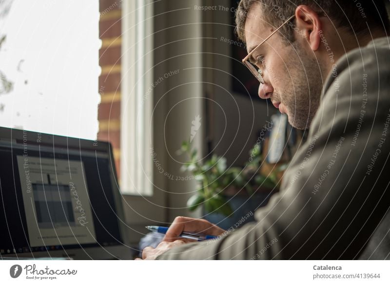 Young man in front of laptop labour at home home office Study Lecture Desk Workplace Online Internet Education Technology Window portrait Digital Notebook