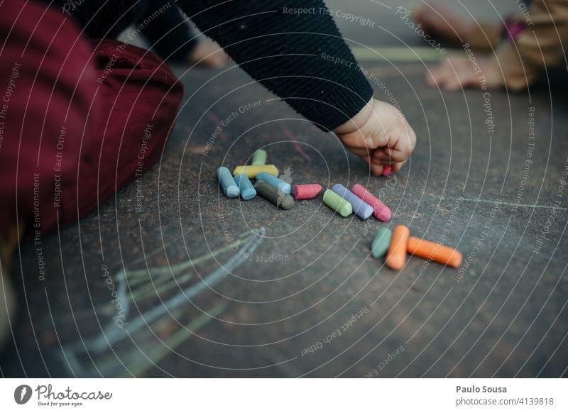 Child drawing with colored chalk on the floor Close-up 1 - 3 years Chalk Chalk drawing Draw Infancy Playing Art Exterior shot Leisure and hobbies