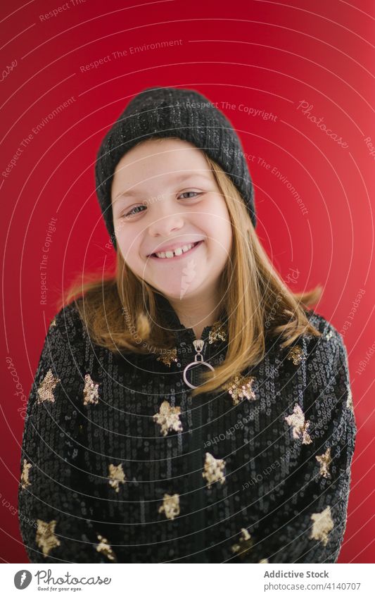 Happy girl in knitted cap and warm sweater positive jersey teeth gap portrait kid child sincere charming childhood carefree sweet candid enjoy pleasant smile