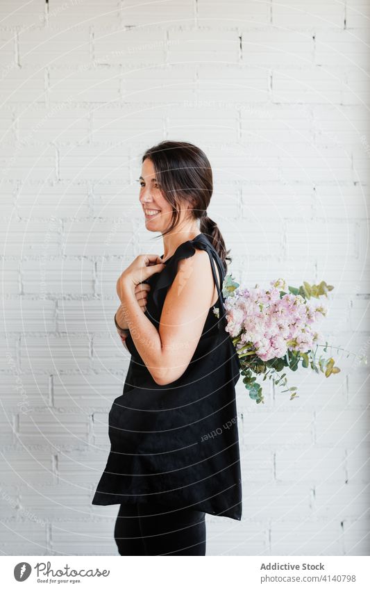 Happy woman with bouquet of pink flowers delicate happy bloom blossom young positive female style flora beautiful elegant floral fresh trendy plant joy decor