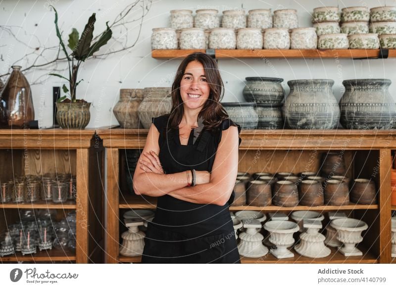 Positive owner of floristry workshop looking at camera woman floral happy success positive confident plant smile cheerful job small business professional