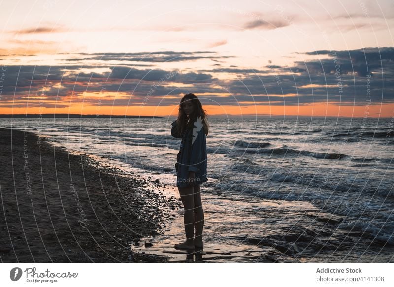 Relaxed woman at seaside in summer seascape sunset traveler beach seashore relax evening silhouette female sundown dusk tourism idyllic tranquil nature sky