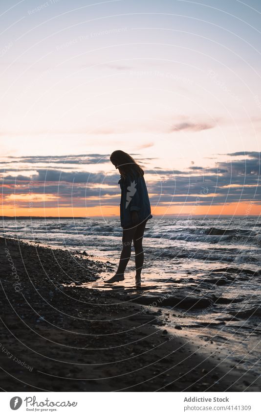 Relaxed woman at seaside in summer seascape sunset traveler beach seashore relax evening silhouette female sundown dusk tourism idyllic tranquil nature sky