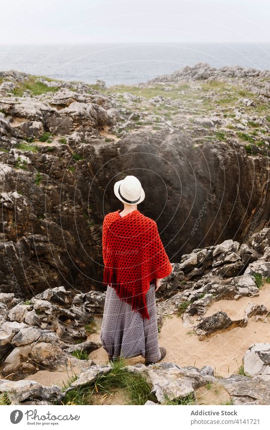 Travelling woman enjoying seascape near geyser coast travel admire nature freedom relax jesters of arenillas spain asturias llanes female style gesture stone