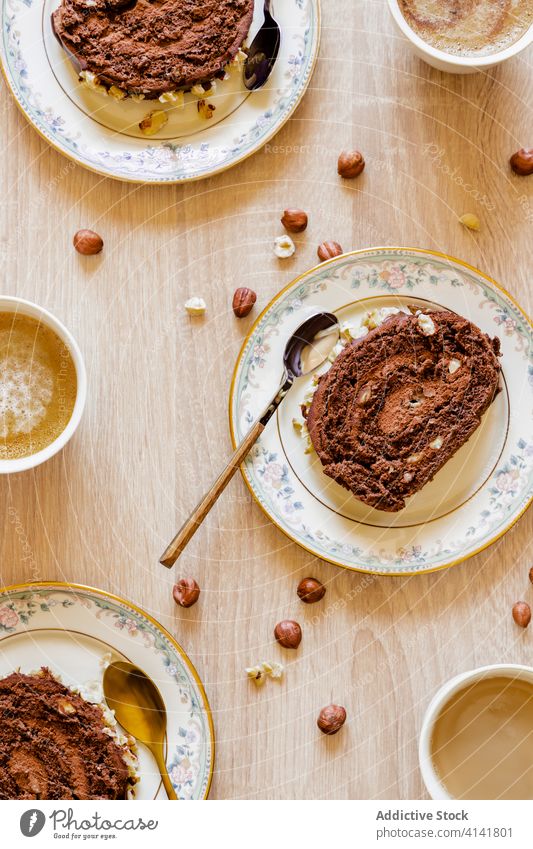 Chocolate cake in plates on table swiss roll portion delicious serve dessert piece hazelnut homemade tasty sweet pastry food gourmet cuisine fresh modern