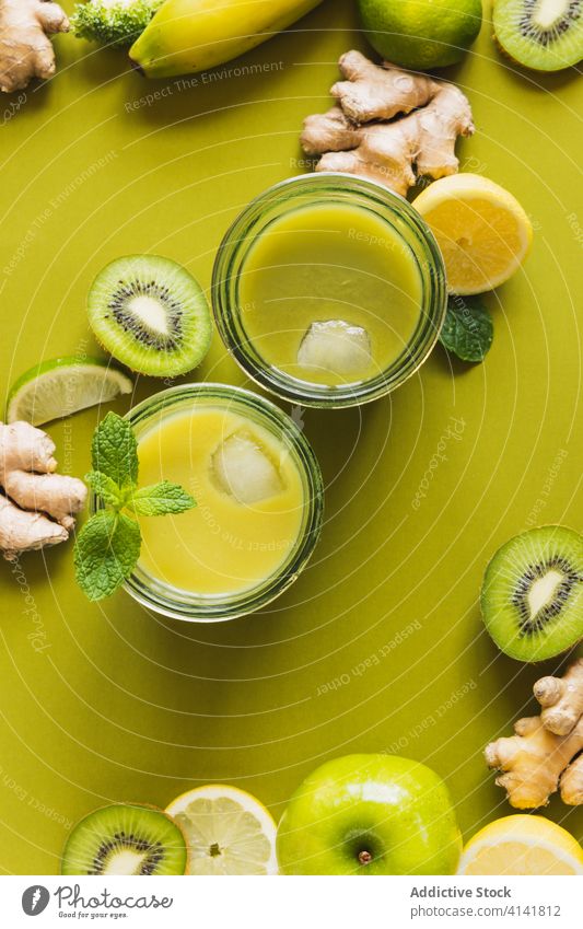 Delicious detox cocktails on tray with lemon and kiwi slices drink beverage juice antioxidant healthy ingredient fruit organic refreshment wooden cube ginger