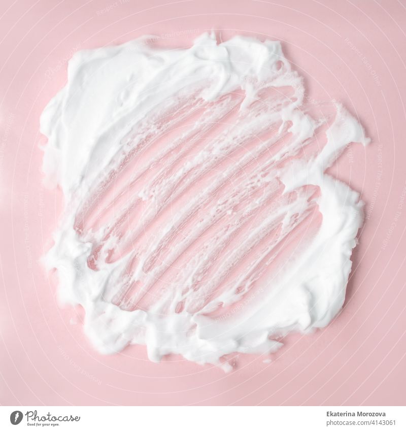 White cosmetic foam texture on pink on pink background. Cosmetic mousse, cleanser, shaving foam, shampoo. Foamy skin care product, skincare, male hygiene concept, copy space