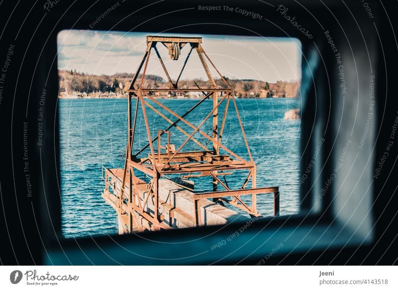 View from the broken window of the old harbour barn on the rusty and aging crane system Looking outlook Window Hollow Blue Light Rectangle Lookout detail Tower