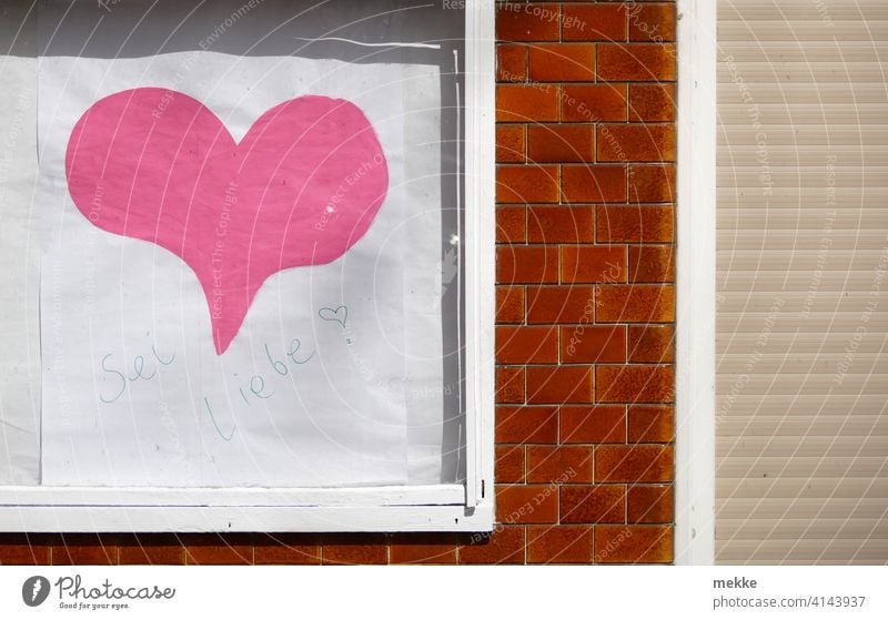 "Be love" in the showcase Heart Shop window Characters Word Advertising Facade Small Town Wall (building) Window Building Signage Clue Load business