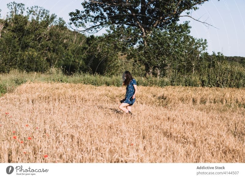 Cheerful woman walking along field run countryside carefree weekend summer sunny freedom cheerful female rubber boot dress joy meadow nature harmony idyllic