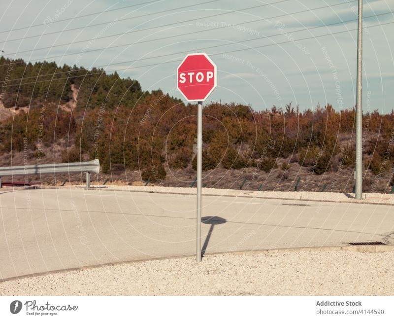 Remote highway with prohibitory road sign stop no entry caution restriction warning red terrain one way regulation octangle signboard notice asphalt roadway