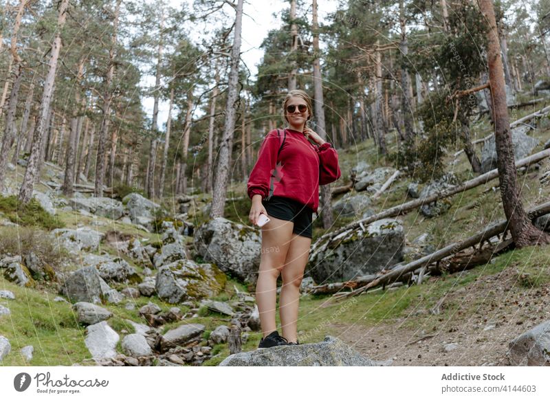 Young woman standing on stone in forest hike travel activity trekking young nature adventure spain navacerrada madrid female hiker journey vacation lifestyle