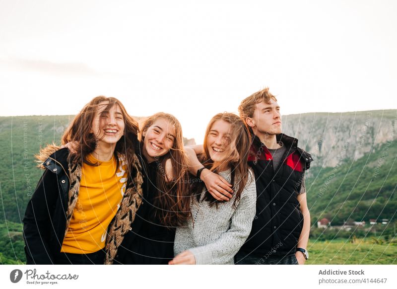 Company of friends together in highlands mountain spectacular friendship hug vacation group sunset transylvania romania saint george happy smile embrace joy