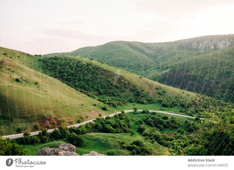 Amazing green valley in highlands spectacular landscape mountain road sunset sky scenery environment transylvania romania forest saint george nature summer