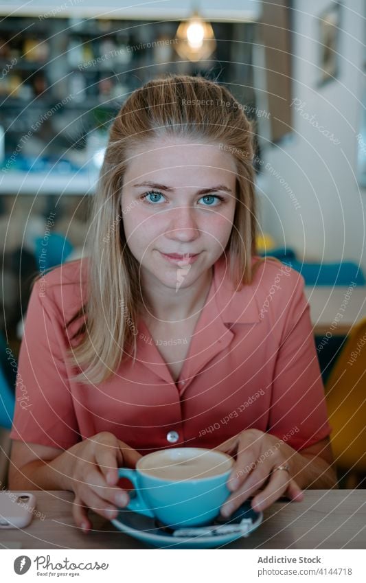 Young woman drinking tea in cafe cup relax rest enjoy coffee chill break beverage aromatic female young lifestyle cafeteria calm tranquil pleasure peaceful