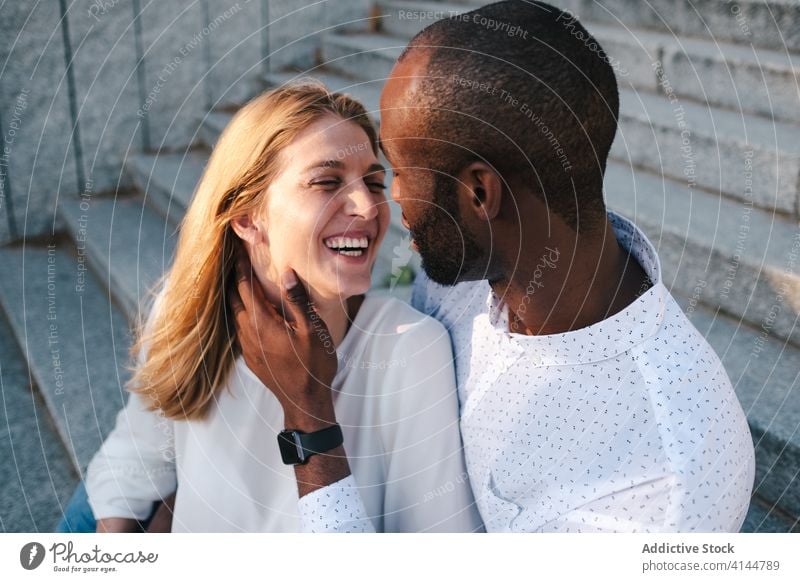 Tender multiracial couple hugging each other lovingly bonding rest in love romantic content tender sensual eyes closed cuddle happy cheerful fondness affection