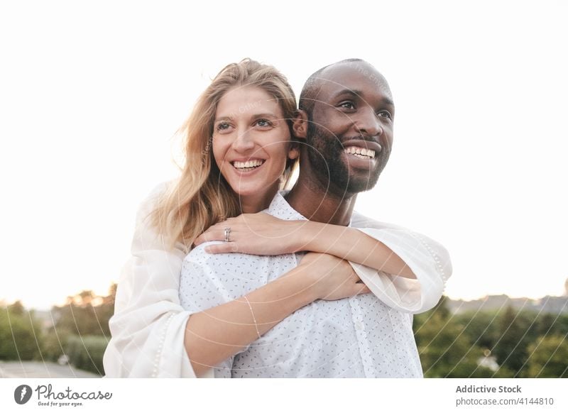 Tender multiracial couple hugging each other lovingly bonding rest in love romantic content tender sensual eyes closed cuddle happy cheerful fondness affection