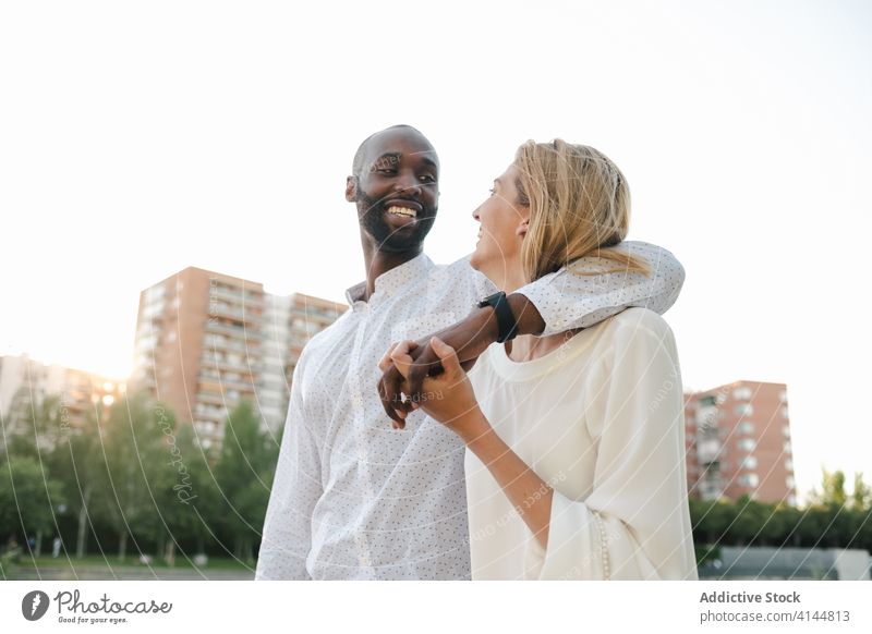 Tender multiracial couple hugging each other lovingly bonding rest in love romantic content tender sensual eyes closed cuddle happy cheerful fondness affection