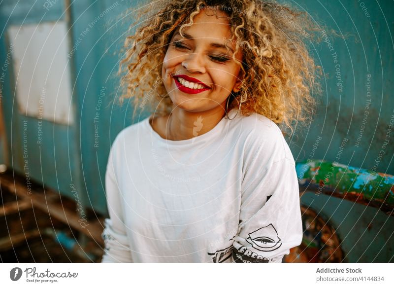 Eccentric ethnic woman in abandoned building millennial style trendy generation grunge independent female black african american city urban stand denim