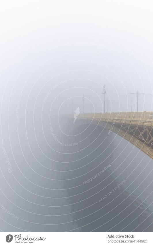 Suspension bridge over river in city suspension fog mist water amazing scenery weather tranquil magnificent peaceful calm wonderful scenic haze overcast serene