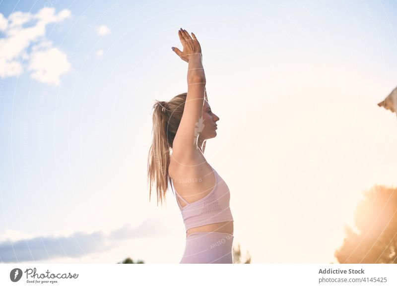 Woman doing yoga in Mountain pose in park mountain pose woman namaste practice calm serene urdhva hastasana sunset female gesture harmony peaceful healthy