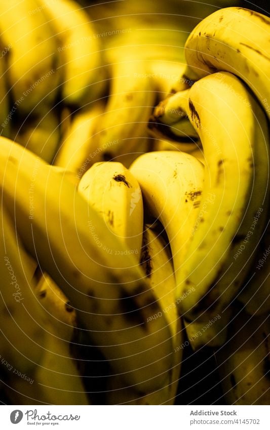 Ripe bananas on local market bunch pile fresh fruit ripe bazaar grocery stall retail counter organic food delicious healthy vitamin natural vegan vegetarian raw