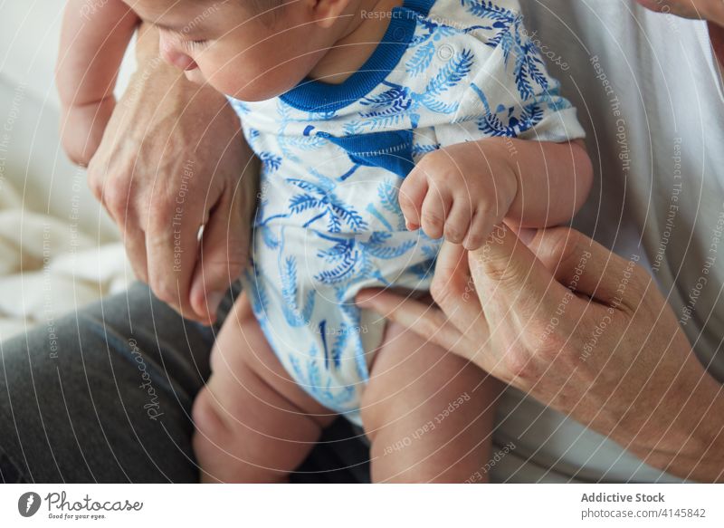 Baby holding his father's hand family baby child boy dad mom mother fun enjoy home at home stay at home beautiful model portrait flat people happy family