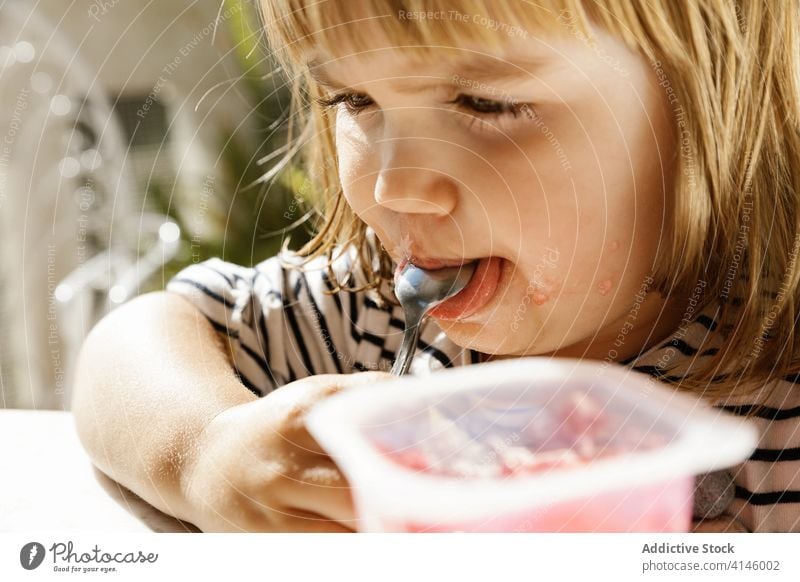 Little girl eating delicious jelly child cute food sweet treat little funny adorable fruit backyard summer sunny kid childhood daytime fresh tasty dessert yummy