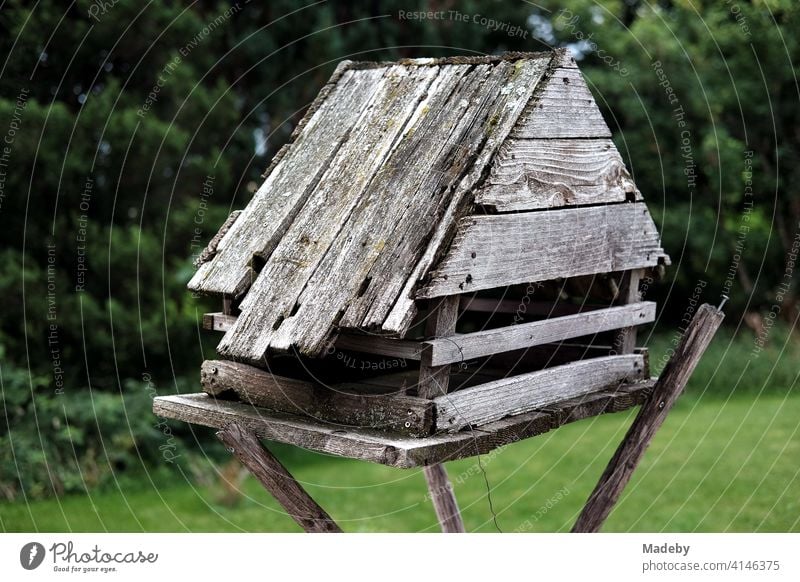 Homemade birdhouse for the winter made of old grey wood at the edge of the forest on a farm in Rudersau near Rottenbuch in the district of Weilheim-Schongau in Upper Bavaria