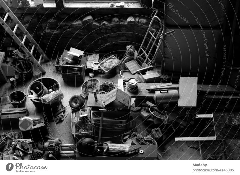 Tools and objects in the workshop of a craftsman in an old barn on a farm in Rudersau near Rottenbuch in the district of Weilheim-Schongau in Upper Bavaria, photographed in classic black and white