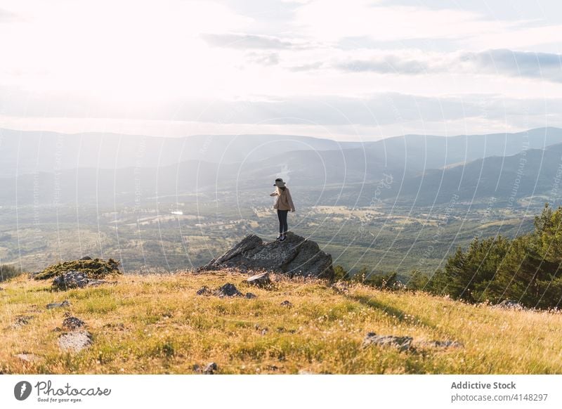 Unrecognizable tourist woman on the rock in mountains landscape traveler valley admire highland vacation sunny hill together nature tourism amazing stone rough