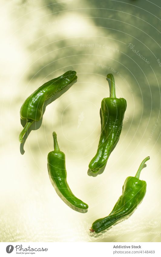 Fresh green peppers on table chili fresh ripe vegetable whole ingredient food natural organic healthy bright raw colorful cuisine spice hot cook culinary flavor