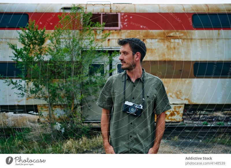 Male photographer near broken train vintage photo camera travel man abandoned railway retro old male usa united states america traveler tourism transport nature