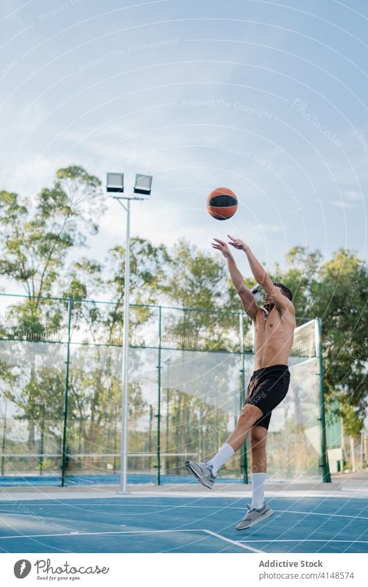 Male basketball player training on playground game man alone sportsman summer male energy healthy sporty muscular street urban sportswear concentrate exercise