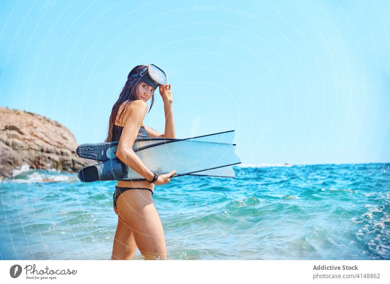 Woman in bikini and goggles in sea diver woman flipper wave water ocean sunlight summer female nature relax stand summertime tropical swimwear paradise idyllic