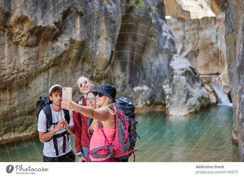 Company of friends taking photo during holiday traveler company take photo selfie together canyon adventure friendship smartphone group happy weekend mobile joy